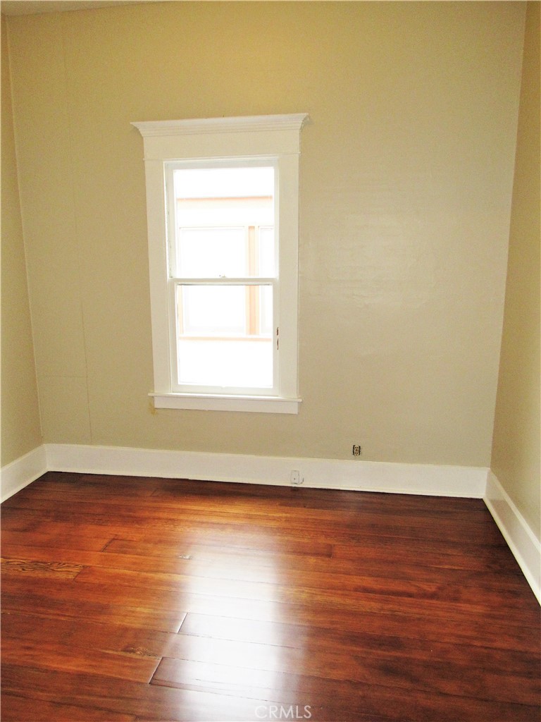 478 South Grand Street Orange, CA 92866 - Photo 6 of 10 an empty room with wooden floor and windows