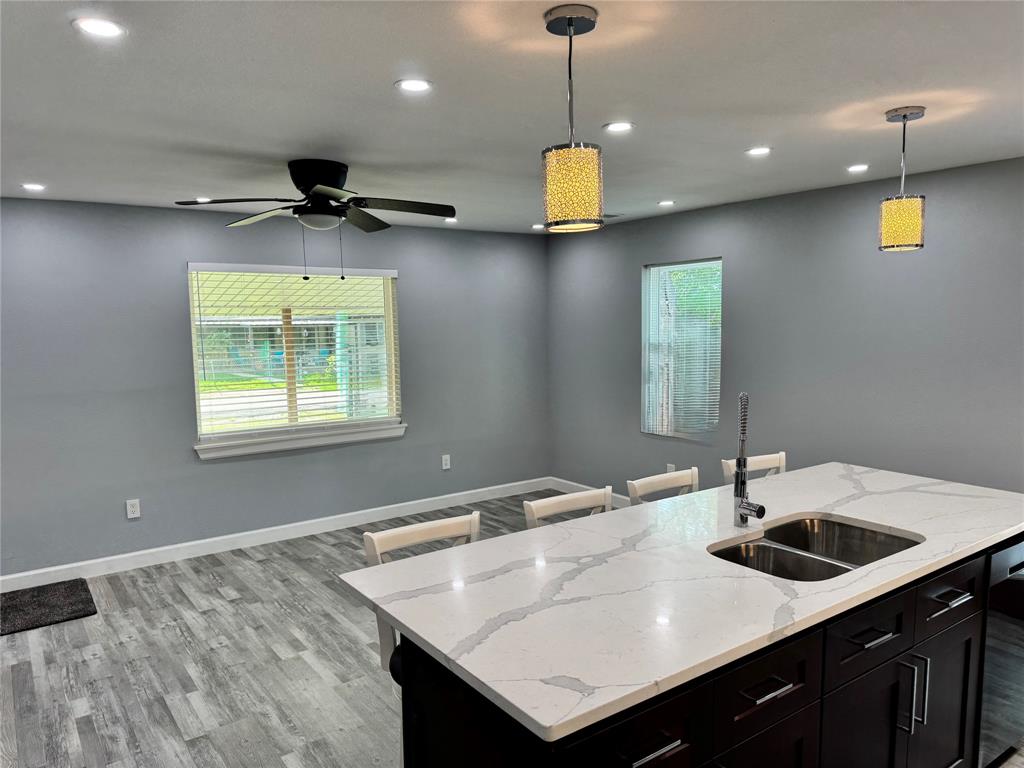 10065 Comanche Road Quinlan, TX 75474 - Photo 5 of 36 a kitchen with a sink a counter space and cabinets