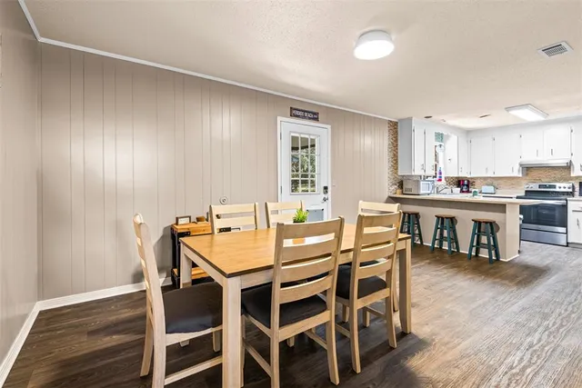 a view of a dining room with furniture and wooden floor