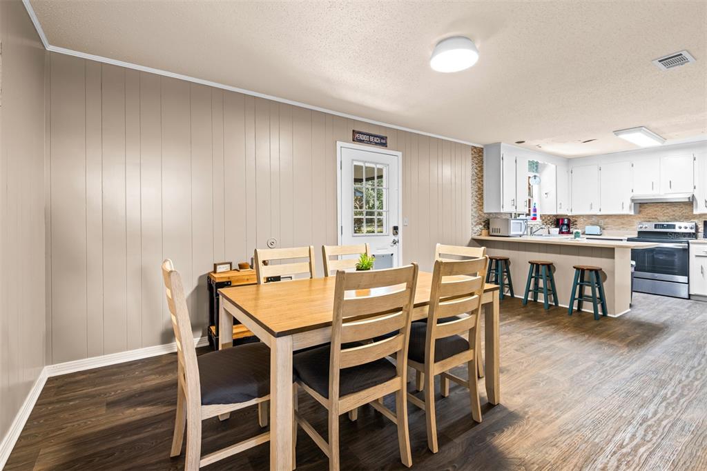 1040 Jocelin Road Pensacola, FL 32506 - Photo 11 of 46 a view of a dining room with furniture and wooden floor