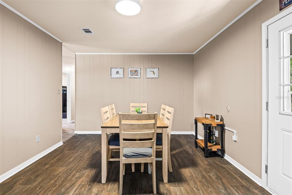 1040 Jocelin Road Pensacola, FL 32506 - Photo 12 of 46 a view of a dining room with furniture and wooden floor