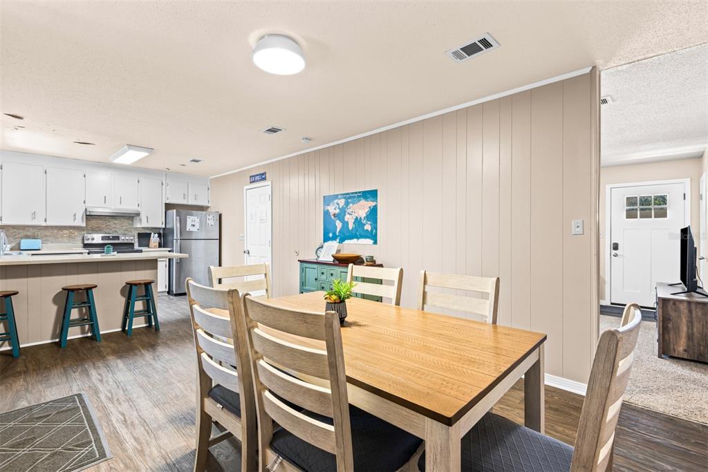 1040 Jocelin Road Pensacola, FL 32506 - Photo 13 of 46 a view of a dining room with furniture and wooden floor