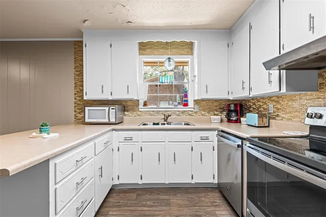 a stove top oven sitting inside of a kitchen