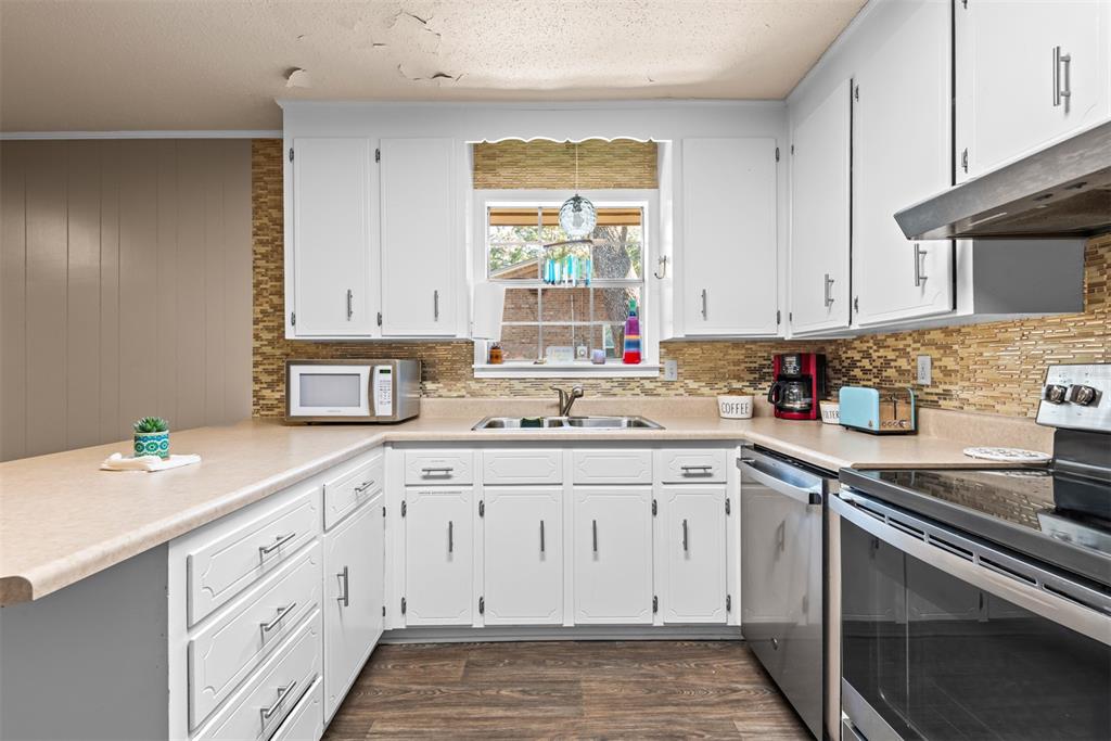 1040 Jocelin Road Pensacola, FL 32506 - Photo 15 of 46 a kitchen with granite countertop white cabinets and white appliances