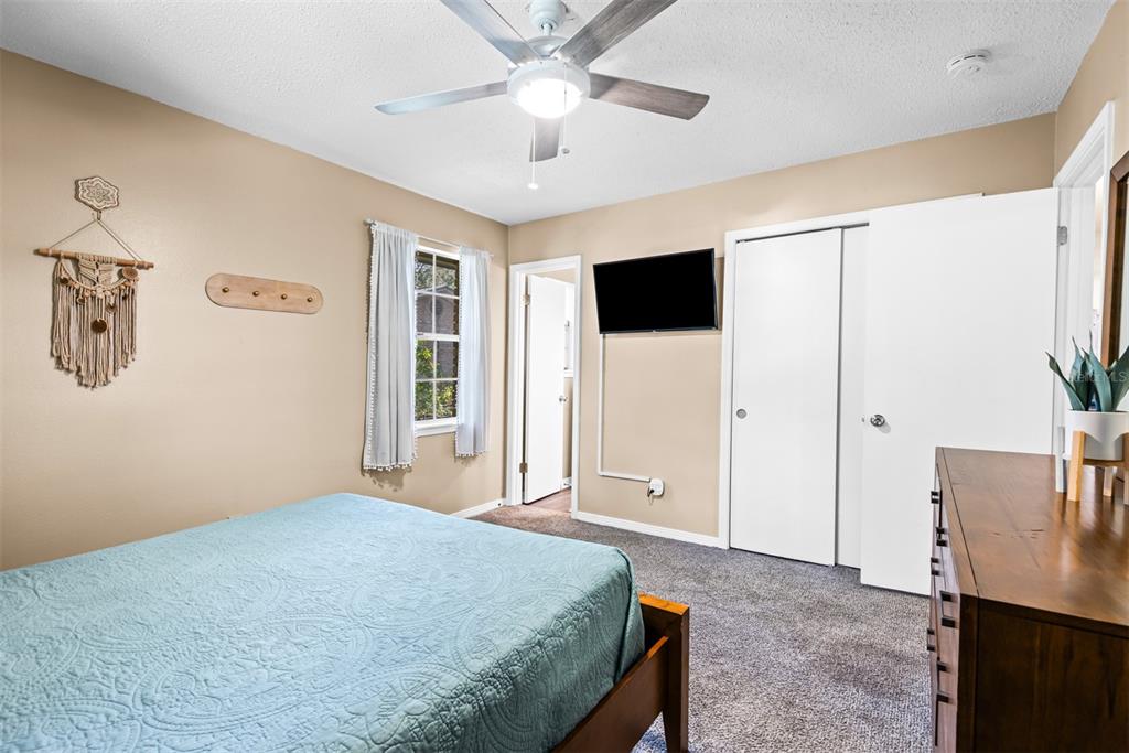 1040 Jocelin Road Pensacola, FL 32506 - Photo 20 of 46 a bedroom with a bed and a flat screen tv