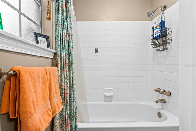 a bedroom with a bed and a flat tv screen on the dresser