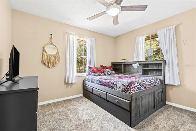 a bedroom with furniture and a window