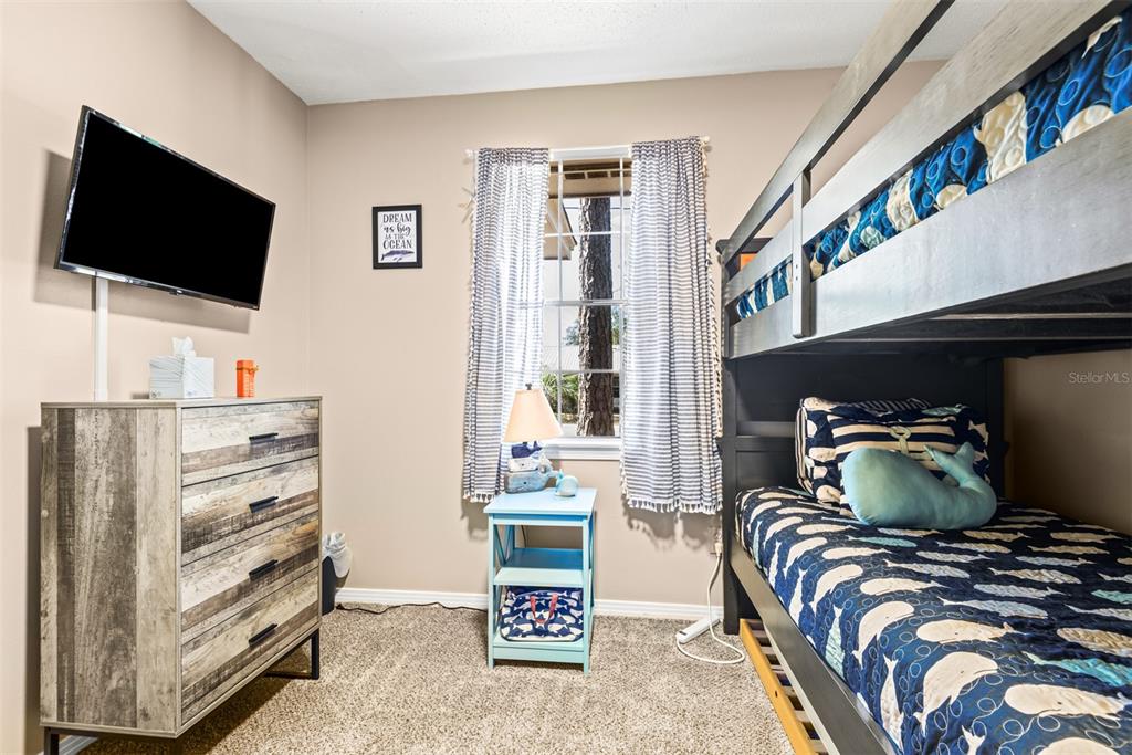 1040 Jocelin Road Pensacola, FL 32506 - Photo 27 of 46 a bedroom with a bed and flat screen tv