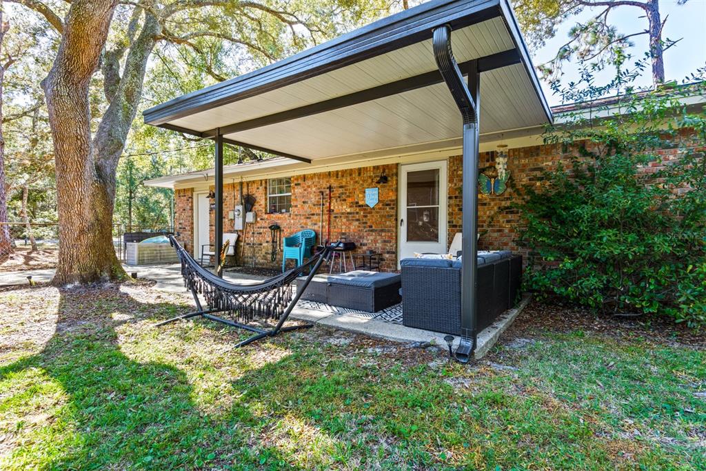 1040 Jocelin Road Pensacola, FL 32506 - Photo 30 of 46 an outdoor sitting area with couch and swing