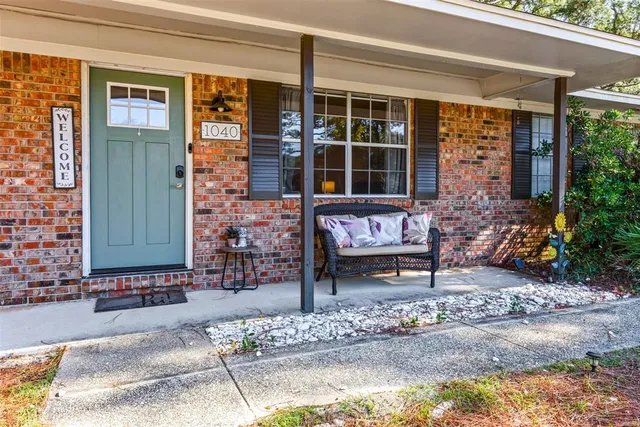 a view of a brick house with a bench in front of it