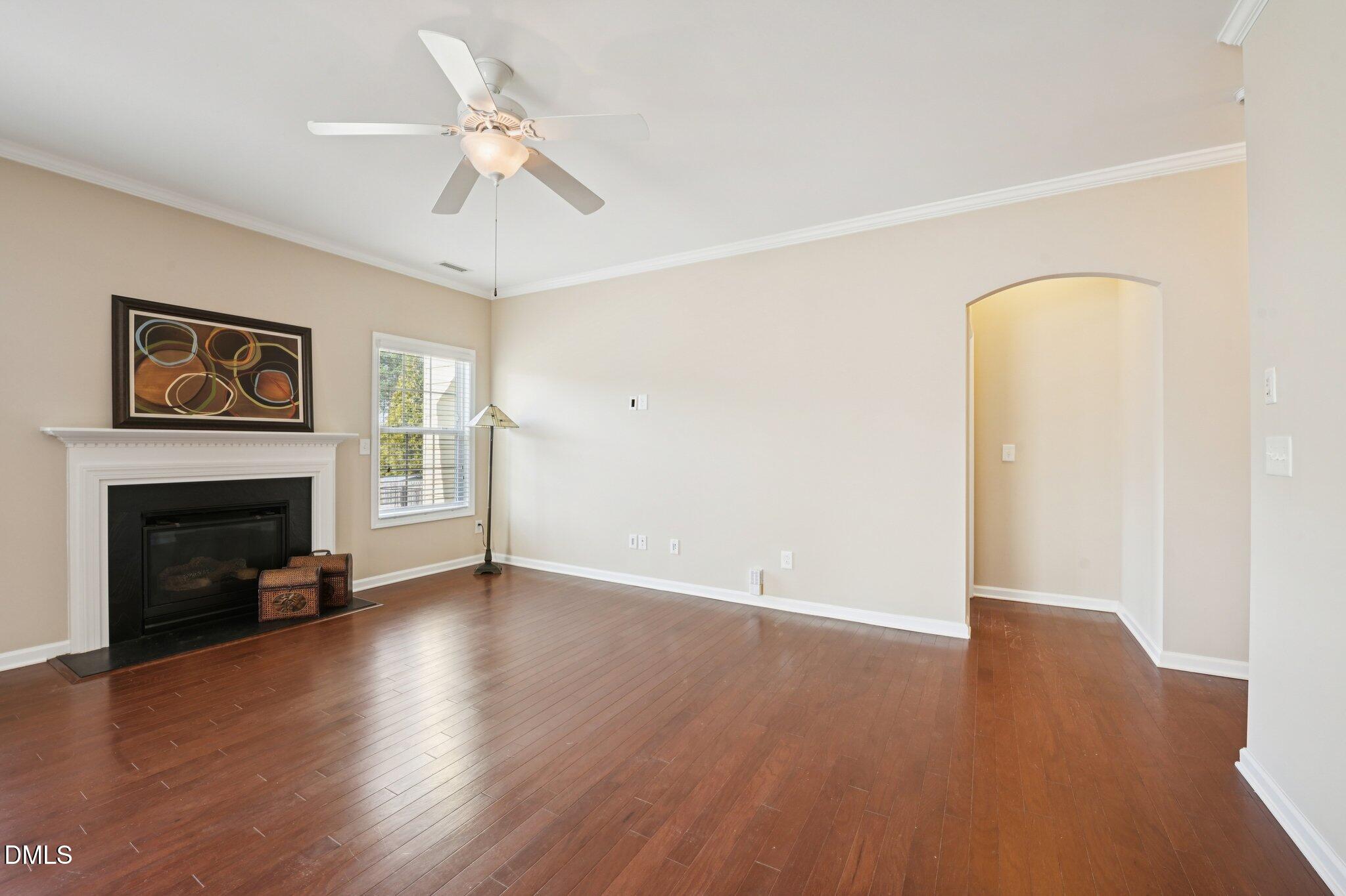 11 Hidden Ridge Court Durham, NC 27707 - Photo 6 of 30 a view of an empty room with wooden floor and a fireplace