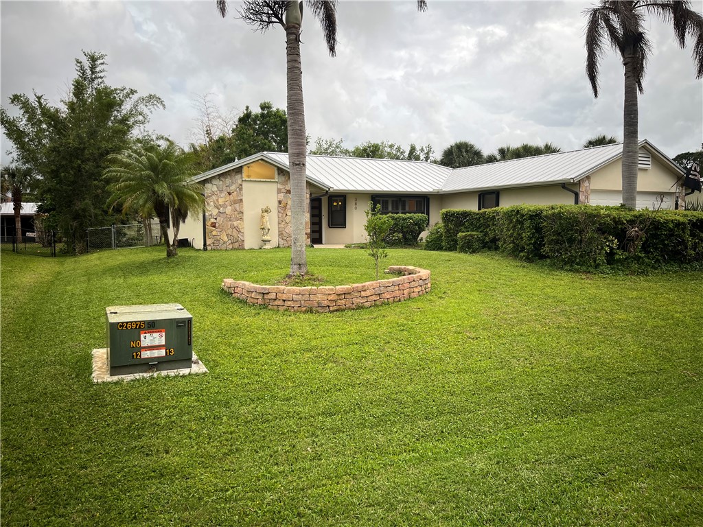 380 Bayfront Terrace Sebastian, FL 32958 - Photo 1 of 32 a front view of a house with garden