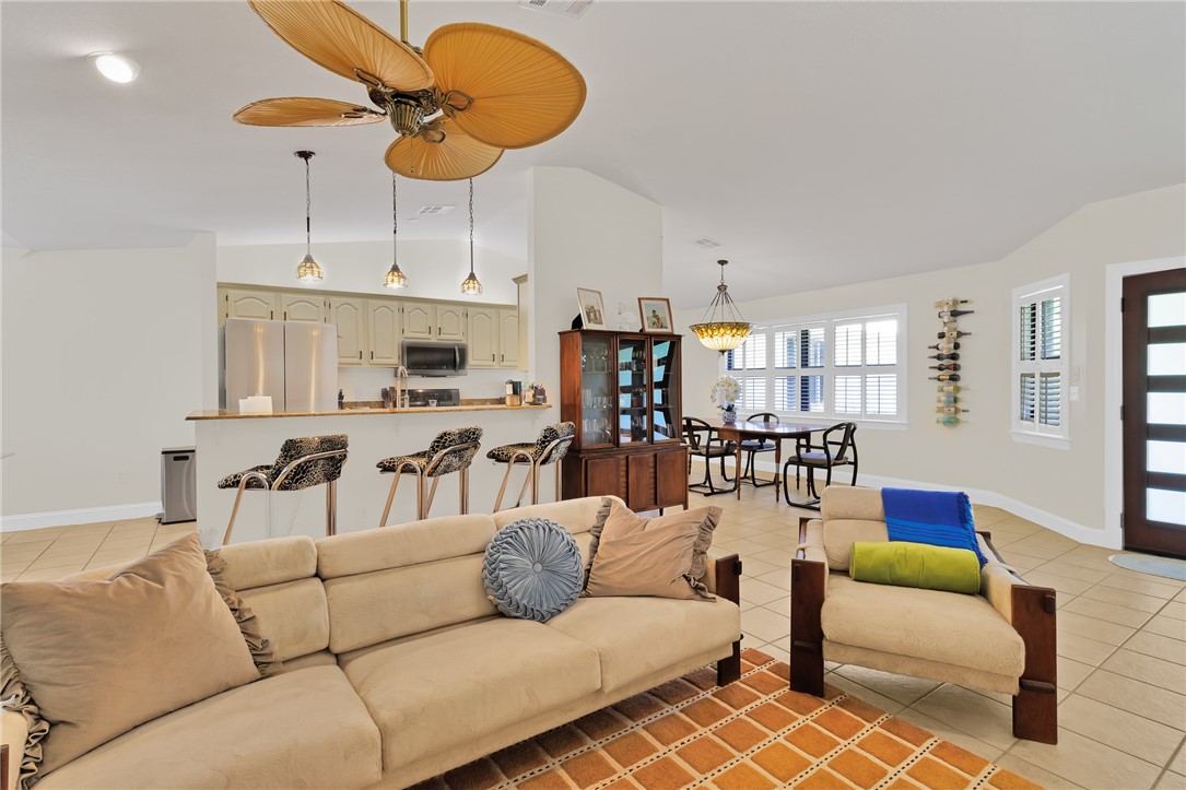 380 Bayfront Terrace Sebastian, FL 32958 - Photo 14 of 32 a living room with furniture kitchen view and a chandelier