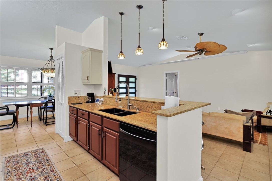 380 Bayfront Terrace Sebastian, FL 32958 - Photo 17 of 32 a kitchen with stainless steel appliances granite countertop a stove a sink and a refrigerator