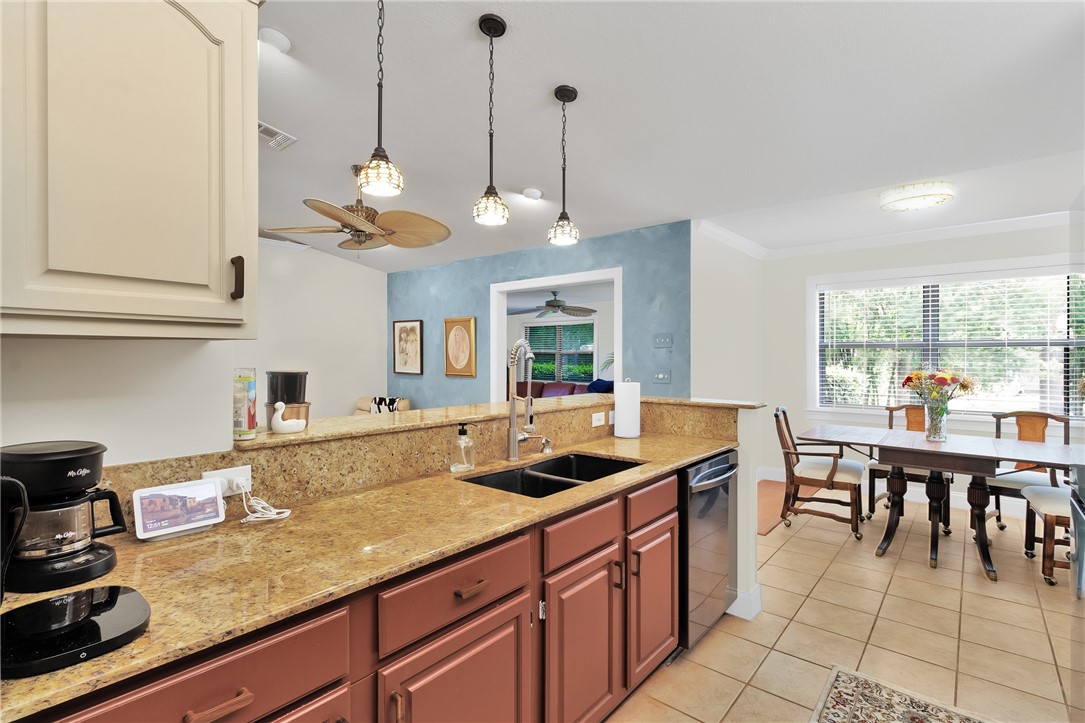 380 Bayfront Terrace Sebastian, FL 32958 - Photo 18 of 32 a kitchen with granite countertop a sink a stove and cabinets