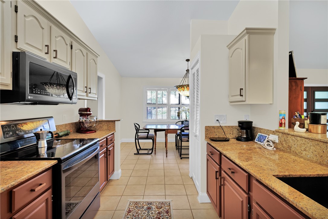 380 Bayfront Terrace Sebastian, FL 32958 - Photo 19 of 32 a kitchen with stainless steel appliances granite countertop a sink stove and cabinets