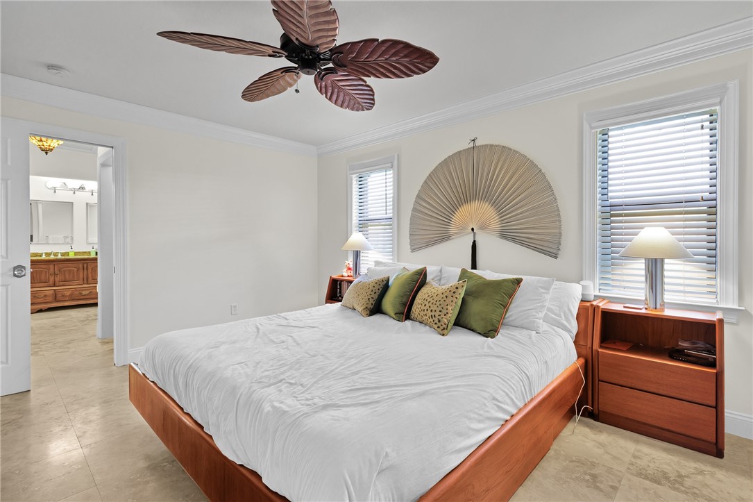 380 Bayfront Terrace Sebastian, FL 32958 - Photo 21 of 32 a bedroom with a bed and a dresser