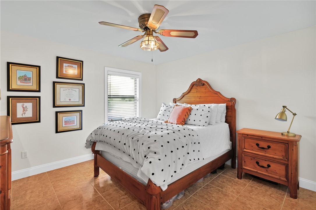 380 Bayfront Terrace Sebastian, FL 32958 - Photo 24 of 32 a bedroom with a bed and a chandelier