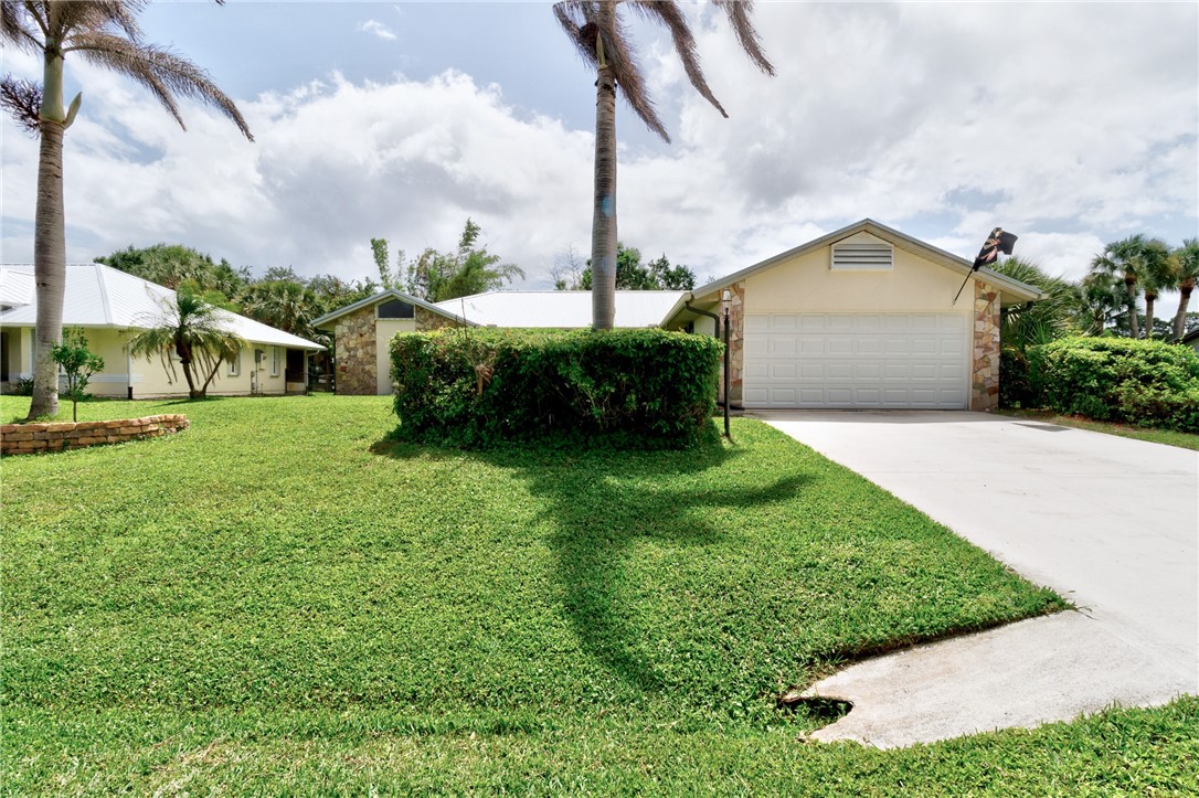 380 Bayfront Terrace Sebastian, FL 32958 - Photo 6 of 32 a front view of a house with a yard and garage