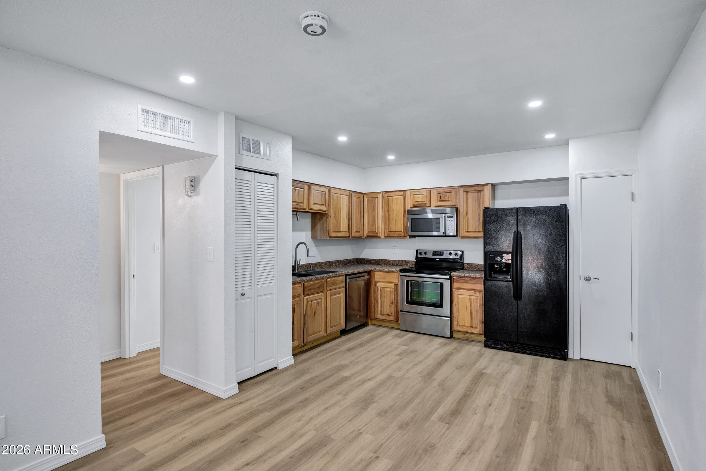 720 South Dobson Road, Unit 39 Mesa, AZ 85202 - Photo 4 of 13 a kitchen with stainless steel appliances granite countertop a refrigerator and a stove top oven