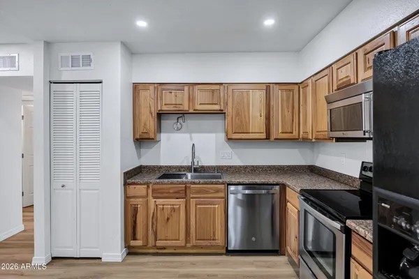a kitchen with stainless steel appliances granite countertop a stove and a sink