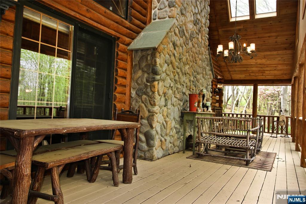 a view of balcony with wooden floor and outdoor seating