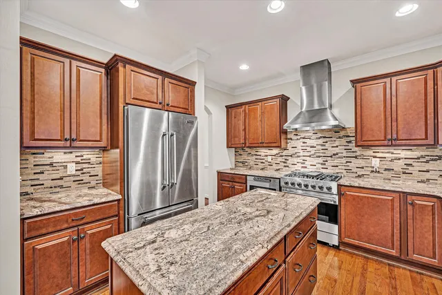 a spacious bedroom with a large bed chandelier and a window