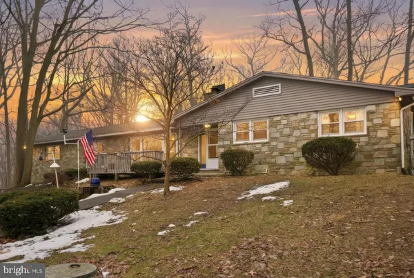 a front view of a house with a yard covered with snow in front of house