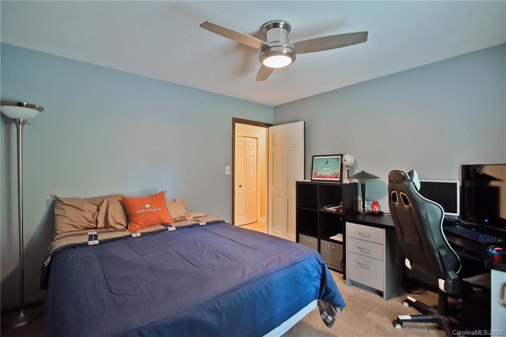 8079 Fairfield Forest Road Denver, NC 28037 - Photo 22 of 40 a bedroom with a bed and wooden floor