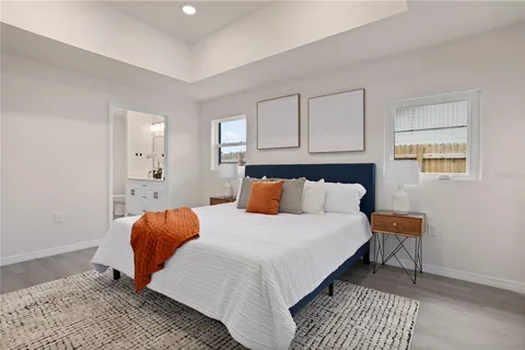 a bedroom with a bed and wooden floor