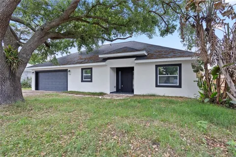 a house that has a tree in front of the house
