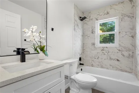 a bathroom with a sink a toilet and a bathtub