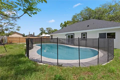 a view of a house with a backyard