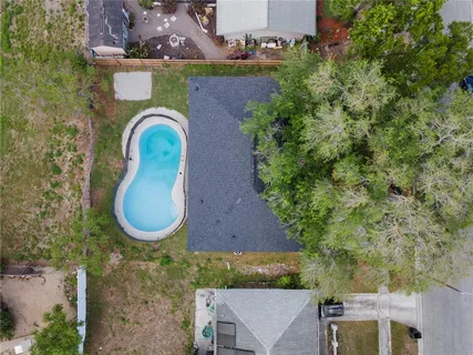 an aerial view of a house with garden space and outdoor seating