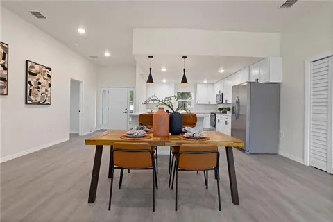 a dining room with furniture and wooden floor