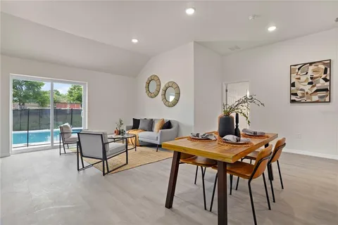 a view of a dining room with furniture and window
