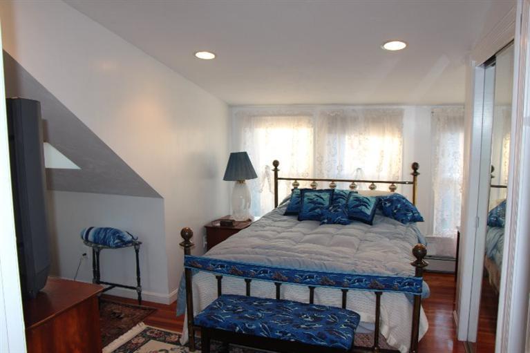 40 Carlisle Road Bourne, MA 02532 - Photo 19 of 28 a bedroom with a bed and a dresser in it
