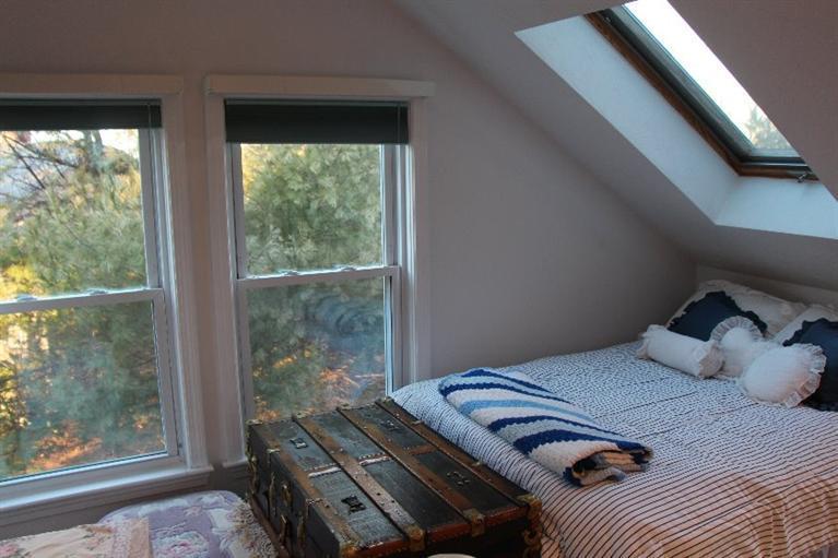 40 Carlisle Road Bourne, MA 02532 - Photo 22 of 28 a bedroom with a bed and wooden floor