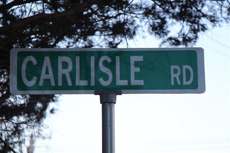 40 Carlisle Road Bourne, MA 02532 - Photo 24 of 28 a white sign that is on the side of a road