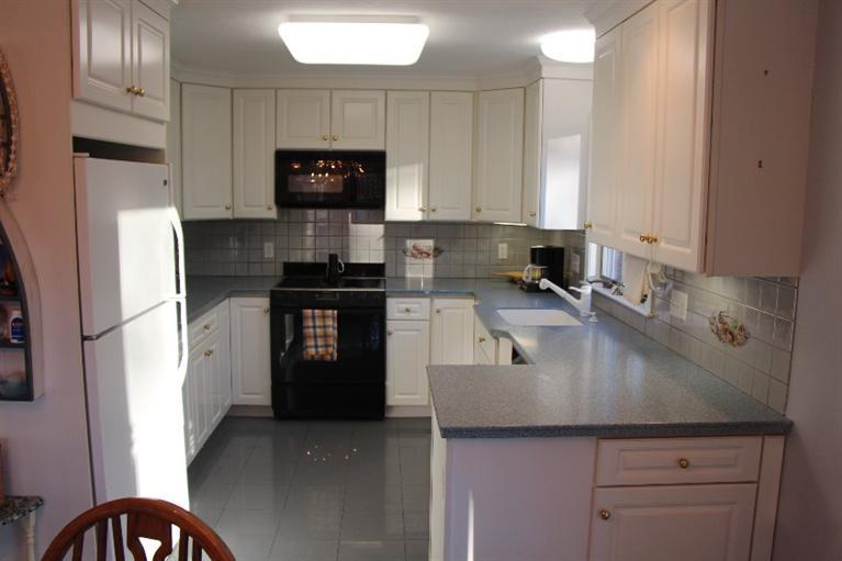 40 Carlisle Road Bourne, MA 02532 - Photo 4 of 28 a kitchen with a refrigerator and a sink