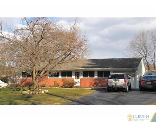 18 Cranston Road Kendall Park, NJ 08824 - Photo 1 of 25 a black and white photo of a house with a yard