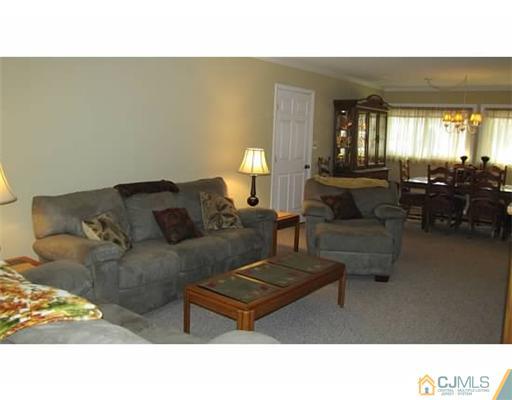 18 Cranston Road Kendall Park, NJ 08824 - Photo 11 of 25 a living room with furniture and a lamp