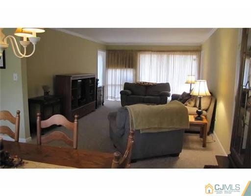 18 Cranston Road Kendall Park, NJ 08824 - Photo 12 of 25 a living room with furniture and a window