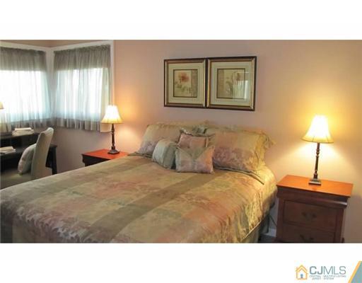 18 Cranston Road Kendall Park, NJ 08824 - Photo 16 of 25 a black and white bed in a room