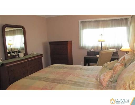 18 Cranston Road Kendall Park, NJ 08824 - Photo 17 of 25 a bedroom with a bed and a mirror