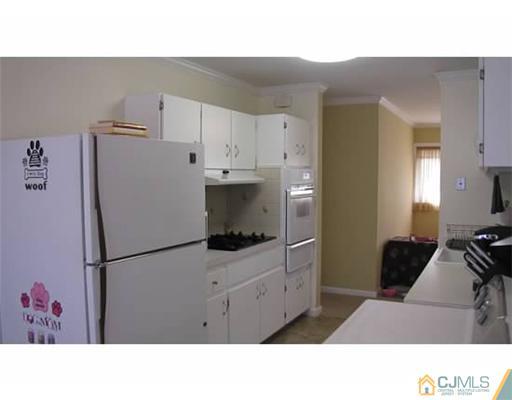 18 Cranston Road Kendall Park, NJ 08824 - Photo 5 of 25 a kitchen with a refrigerator and a sink