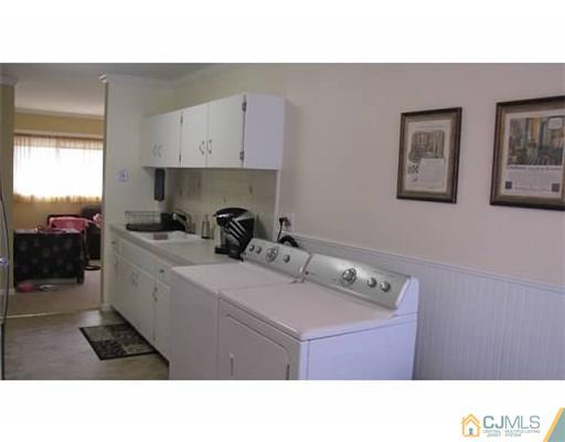 18 Cranston Road Kendall Park, NJ 08824 - Photo 6 of 25 a kitchen with a sink a stove and cabinets
