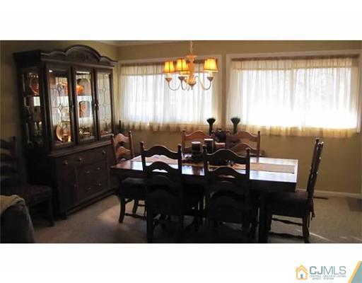 18 Cranston Road Kendall Park, NJ 08824 - Photo 7 of 25 a kitchen with a table chairs and window