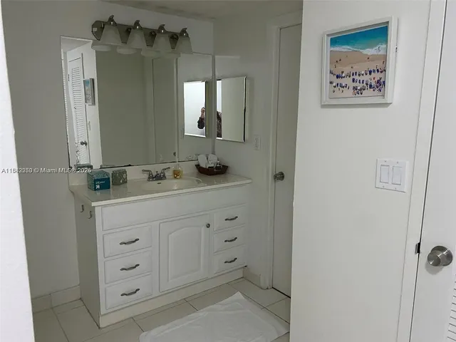 a view of a patio with table and chairs under an umbrella with a fire pit and barbeque grill