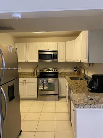 a bedroom with furniture and a large window